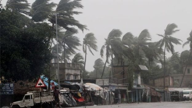 Wind gusting up to 185km/h (115mph) bent palm trees on the Orissa coast