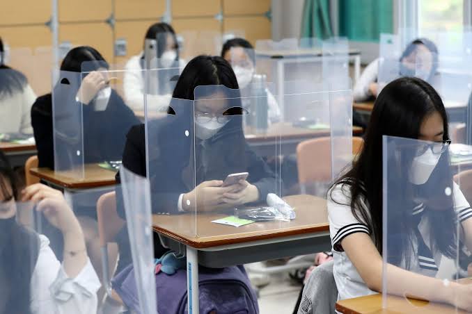 At high school in South Korea pupils are seeming seated behind a protective screen to comply with safety measures, in order to avoid COVID-19 infection.