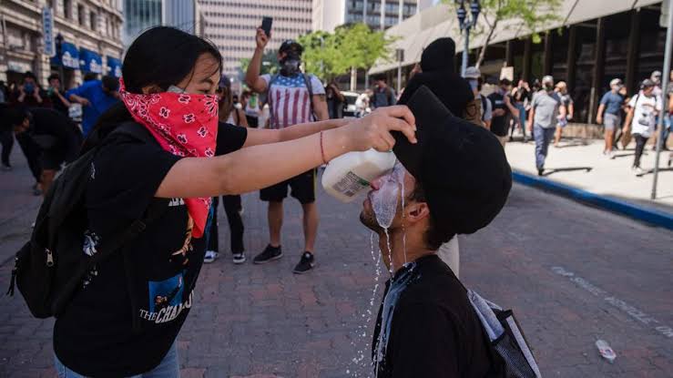 In the city of Michigan, Detroit on May 29, after the attack with CS gas on demonstrators to halt riot, the milk is poured on the face of a protestor can be seen in the image.